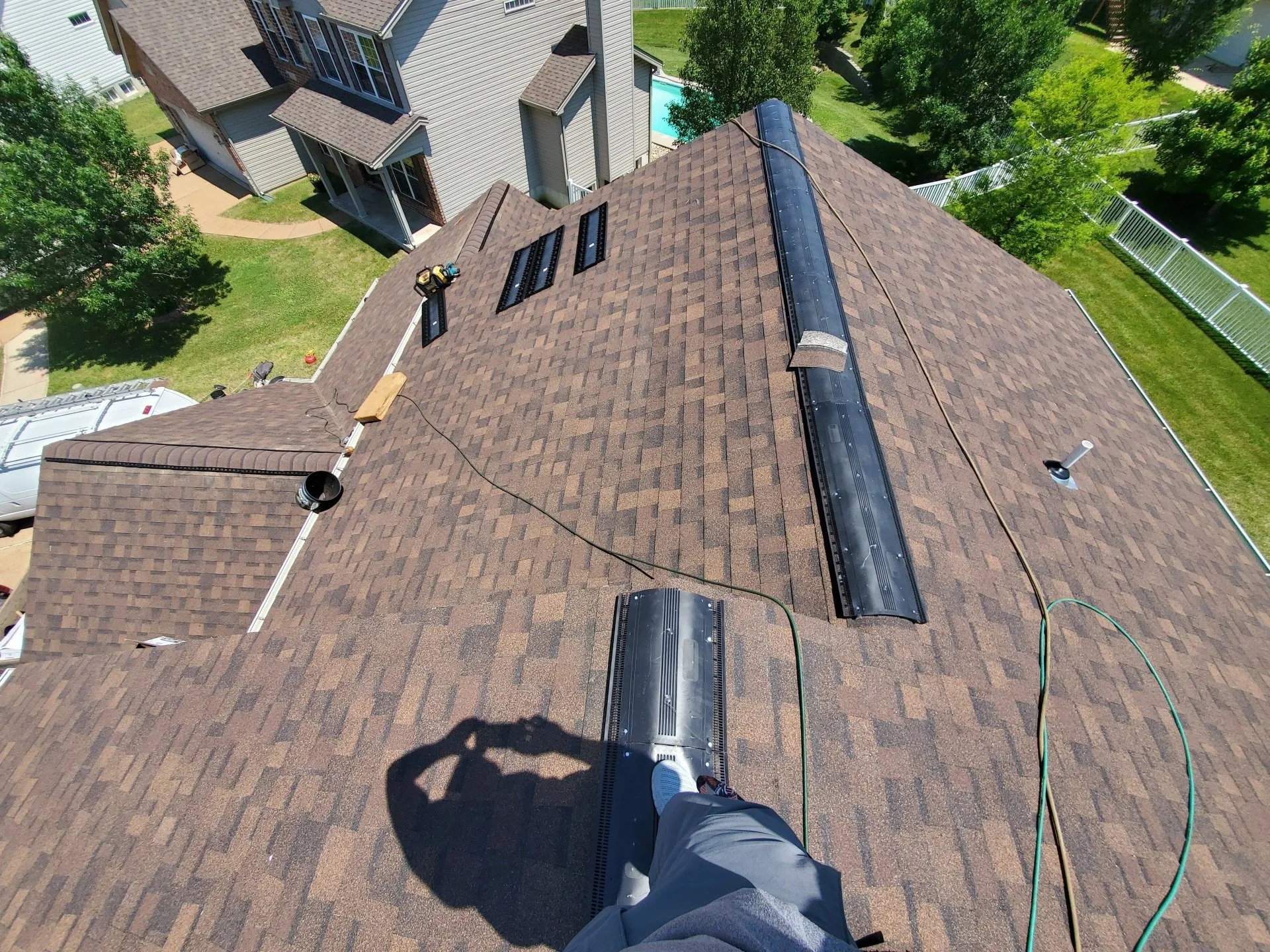 Roofers working on suburban house roofing project