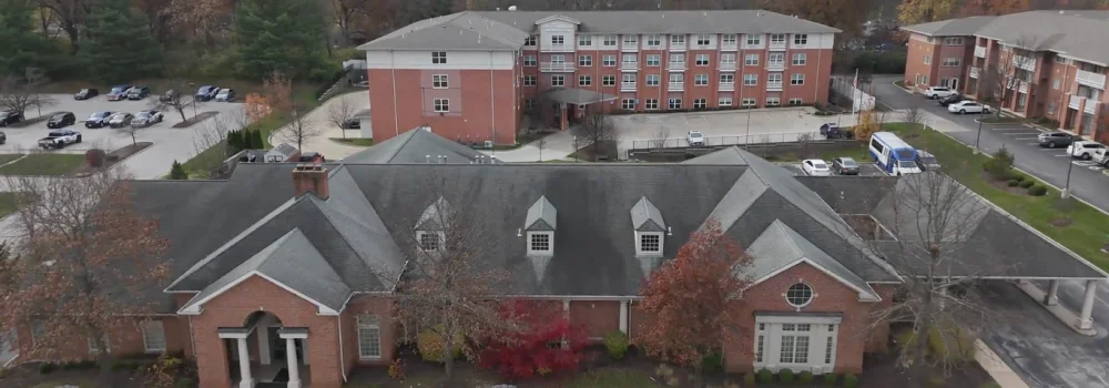 Aerial view of red-brick buildings and parking lot