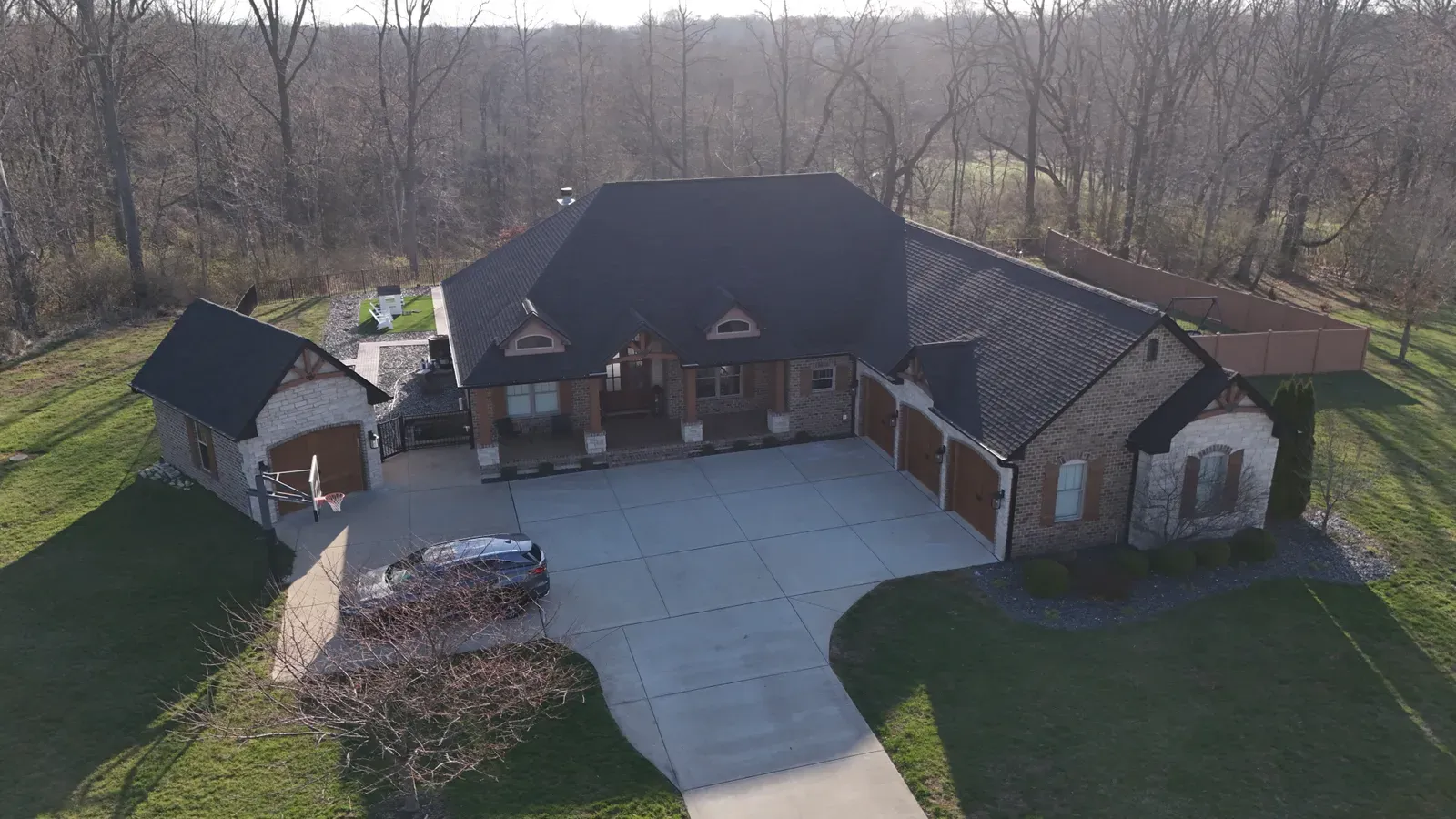 Aerial view of a black shingle roof on a brick ranch home