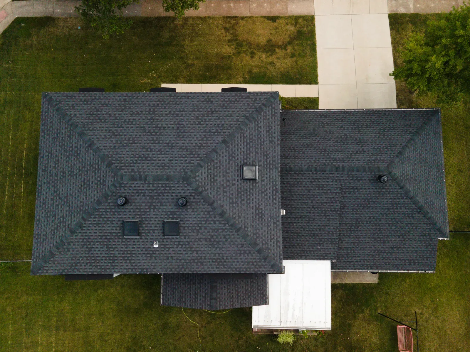 Aerial view of a completed charcoal asphalt shingle roof replacement