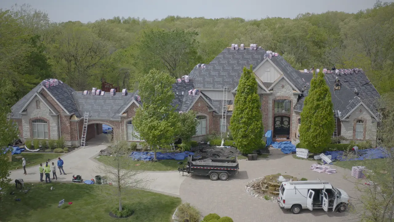 Aerial view of a suburban house with brown roof.